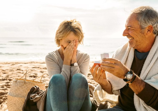 Older couple getting engaged at the beach